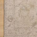 Top-down view of corner on light wood floor highlighting fine woven border and pattern details