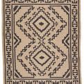 Flatwoven tribal medallion rug in beige and black with fringed edges from the Jaima Bedouin collection