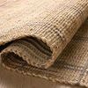 Close-up of Judy Natural / Stone Rug folded to show thickness and woven jute-cotton texture