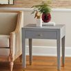 Claudette Side Table styled in living room with red rug and decorative items on top