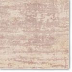 Close-up of the rug's textured surface with fine ribbed details and abstract mauve and cream pattern