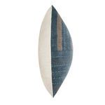 Side view showing pillow's blue patchwork fabric with natural linen back