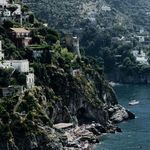 Cropped view focusing on rocky cliffs and houses from Positano beach photograph on aluminum print