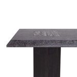Side profile of table showing slim marble top over single trapezoidal pedestal base