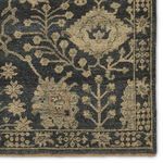 Close crop on corner floral motif with contrast between dark gray background and khaki pattern