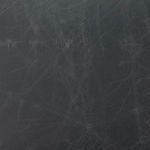 Detailed close-up of smoke-black top-grain leather showing fine natural creases