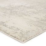 Close-up on corner showing edge binding and texture of gray and ivory abstract pattern