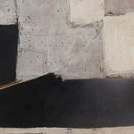 Close-up showing smooth black paint area with visible brushstrokes and some fine texture