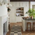 Runner-size Bradley rug in a kitchen with cream cabinets and wooden stools