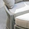 Detailed side corner view showing hand-wrapped rope intersections and cushion piping on light fabric