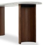 Back view showing symmetry of brown acacia crescent legs supporting white marble console top