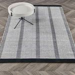 Area rug styled in room setting with small round white tray table on top