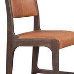 Close-up side detail of leather seat and curved ash wood leg with visible wood grain