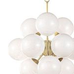 Close-up showing upper half of white swirl globes with brass connecting hardware