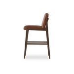 Side view highlighting padded seat and backrest thickness with dark wood frame