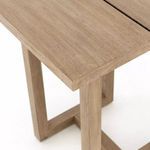 Detailed close-up of the top corner edge and wood grain of the outdoor bar table