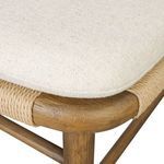 Close-up of cushion fabric and woven rope wrapping around chair seat frame