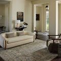 Rug placed in a spacious living room with neutral-toned furniture and natural light enhancing muted colors