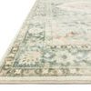 Angled close-up showing Rosette rug’s pile, soft edges, and detailed floral border