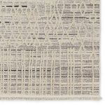 Detail of rug corner showcasing fringe and distinct trellis and linear pattern texture