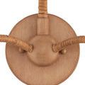 Close-up focused on round wall mount with natural tan wooden finish
