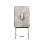 Front view of tall bar cabinet showing symmetrical hair-on-hide doors and slender brass crossbar legs