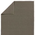 Top view with one corner flipped over showing both sides of the handwoven gray rug