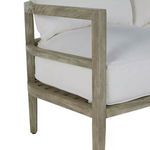 Close-up of teak wood armrest and white sofa cushion, highlighting the slatted wood design