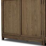 Lower front portion of cabinet showing solid wood doors with framed panel design and short block feet