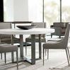 Lowell dining chairs surrounding round white dining table in bright modern room with glass walls