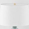 Close-up of the wide white drum lampshade and gold finial top