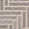 Extreme close-up showing looped wool and viscose fibers forming geometric pattern in warm gray and ivory