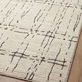 Angled close-up of Darby Sand / Dk. Grey rug showing ribbed surface and dark linear pattern on neutral background