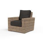 Outdoor Havana Club Chair in weathered tobacco wicker with dark charcoal cushions and wide armrests