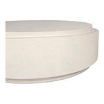 Close angled view focusing on subtle textural speckles on white concrete table edge