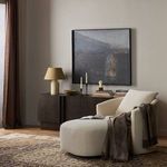 Farrah Chaise Lounge styled in a room with area rug, dark wood console, and abstract wall art