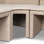 Tight focus on inner angle of L-shaped banquette with fabric cushions