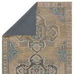 Top view showing dark backing of the rug folded over one corner