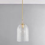 Pendant hanging from ceiling shown with light off against grey wall background