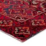 Close-up showing edge and texture of low pile polypropylene rug with intricate color details