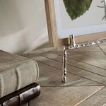 Close-up of silver bamboo-like texture on the bottom right corner of Baldwin Easel holding a frame