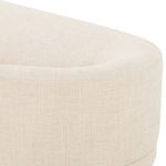 Close-up of sofa’s light taupe fabric upholstery showing subtle woven texture and curved back