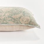 Close-up side angle showing the floral pattern and striped piping detail against beige pillow back