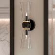 Byford Bath Wall Sconce mounted on wall with partial view of marble tiles and shower fixtures in bathroom