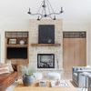 Heirloom Aqua Stone Rug styled in bright living room with wooden coffee table, leather sofa, and stone fireplace