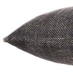 Close-up side view showing dark gray woven texture with hand-spun wool fibers on pillow