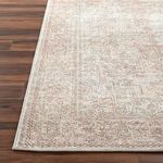 Tight corner shot of Margot rug highlighting low pile and finely machine-woven edges on dark wood flooring