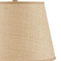 Close-up on the lamp’s beige woven rattan drum shade with visible weave pattern