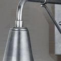 Close-up of Mariner sconce's conical shade and curved arm showing antique silver patina texture
