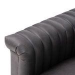Detail of rolled armrest edge with channel stitching in dark gray leather